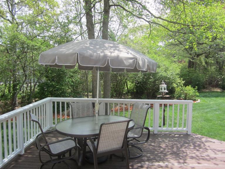 10 Captain Kidd Road East Sandwich, MA 02537 - Photo 23 of 31 a view of a patio with a table chairs under an umbrella