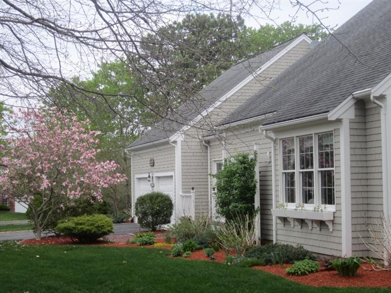10 Captain Kidd Road East Sandwich, MA 02537 - Photo 5 of 31 a front view of a house with a yard and potted plants