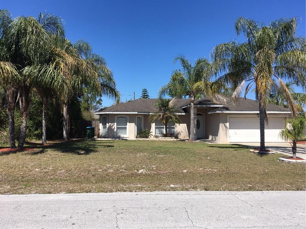 1729 Concert Road Deltona, FL 32738 - Photo 1 of 1 a view of a house with a yard and palm trees