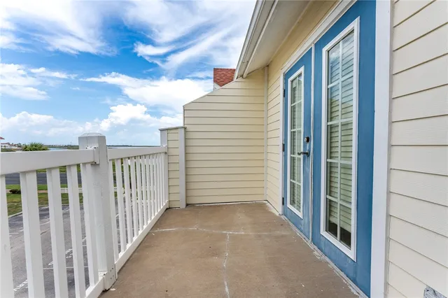 a view of a balcony with wooden fence