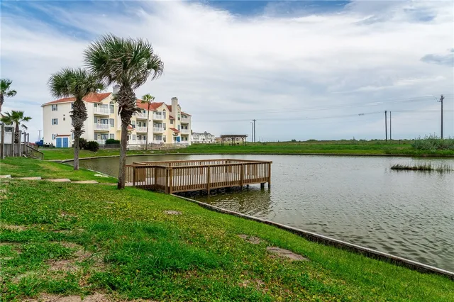 a view of a house with a yard and a fountain