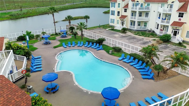 a view of a swimming pool with outdoor seating