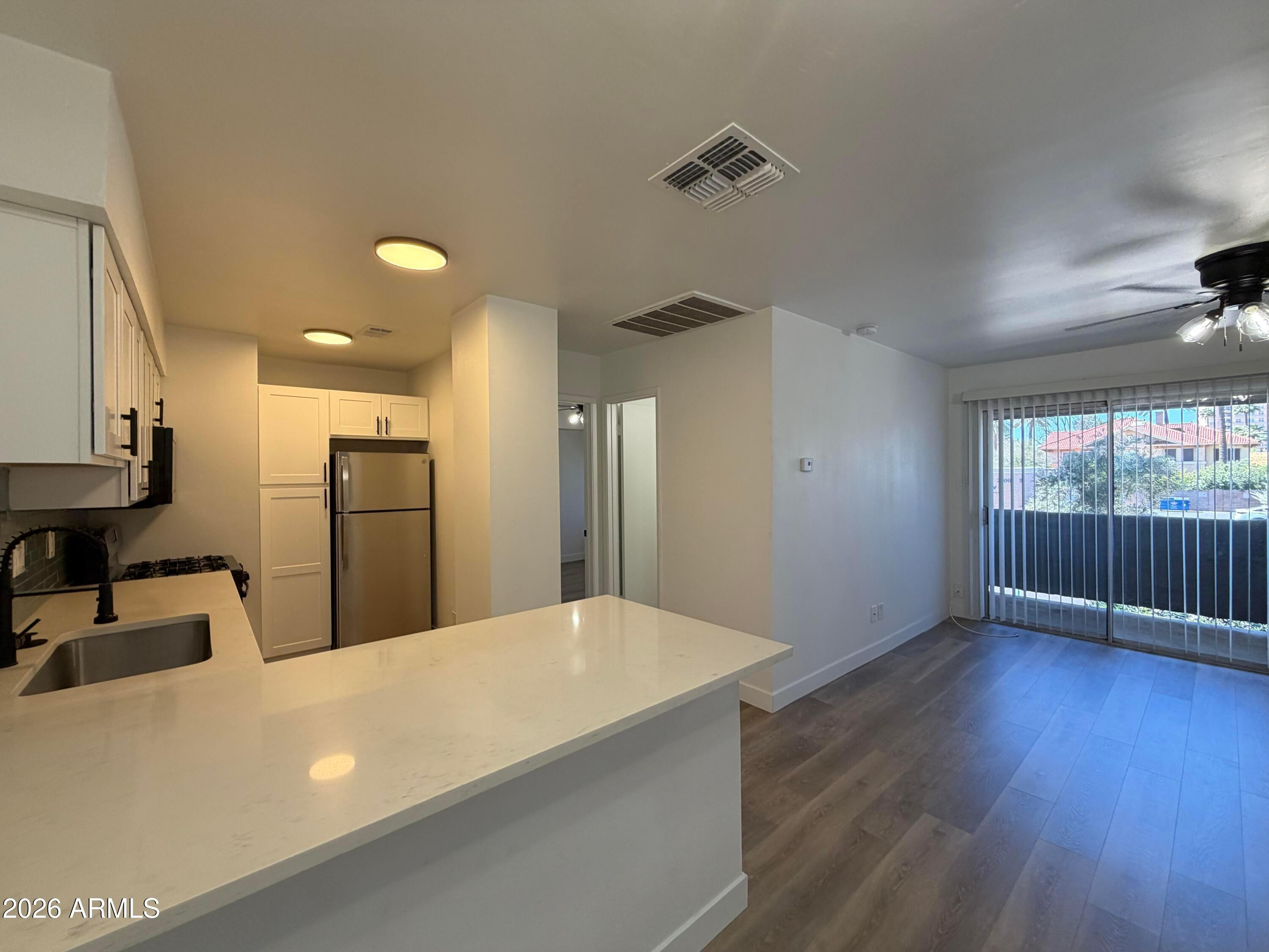 a view of kitchen with furniture and wooden floor