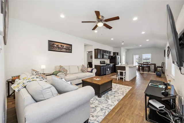 a living room with furniture and kitchen view