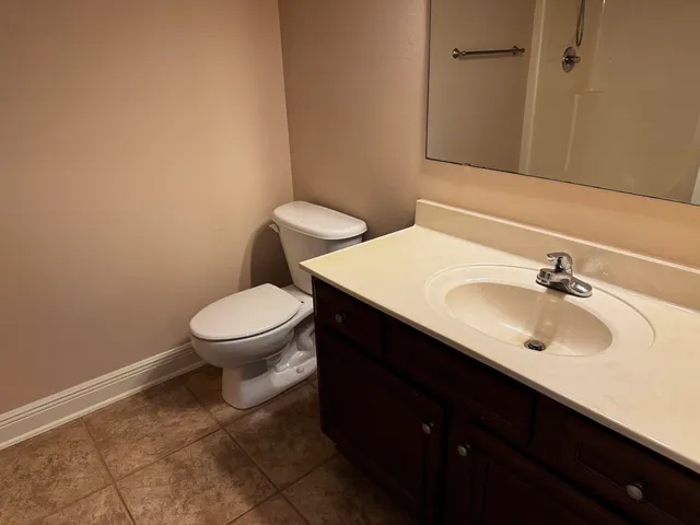 a bathroom with a sink toilet and a mirror