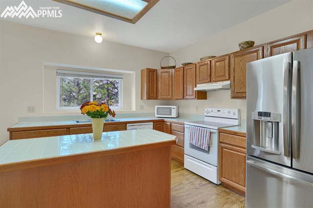 7405 Julynn Road Colorado Springs, CO 80919 - Photo 8 of 21 All appliances included. Room to get organized!