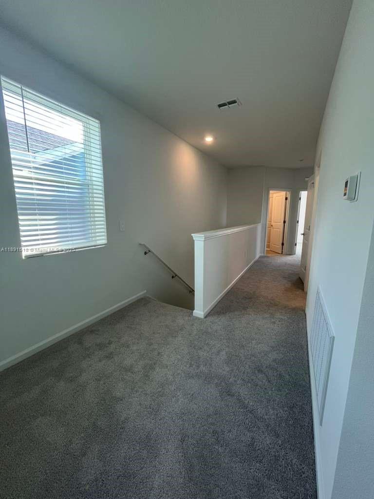 5984 Zen Way, Unit 5984 Clermont, FL 34714 - Photo 18 of 51 a view of an empty room with a window