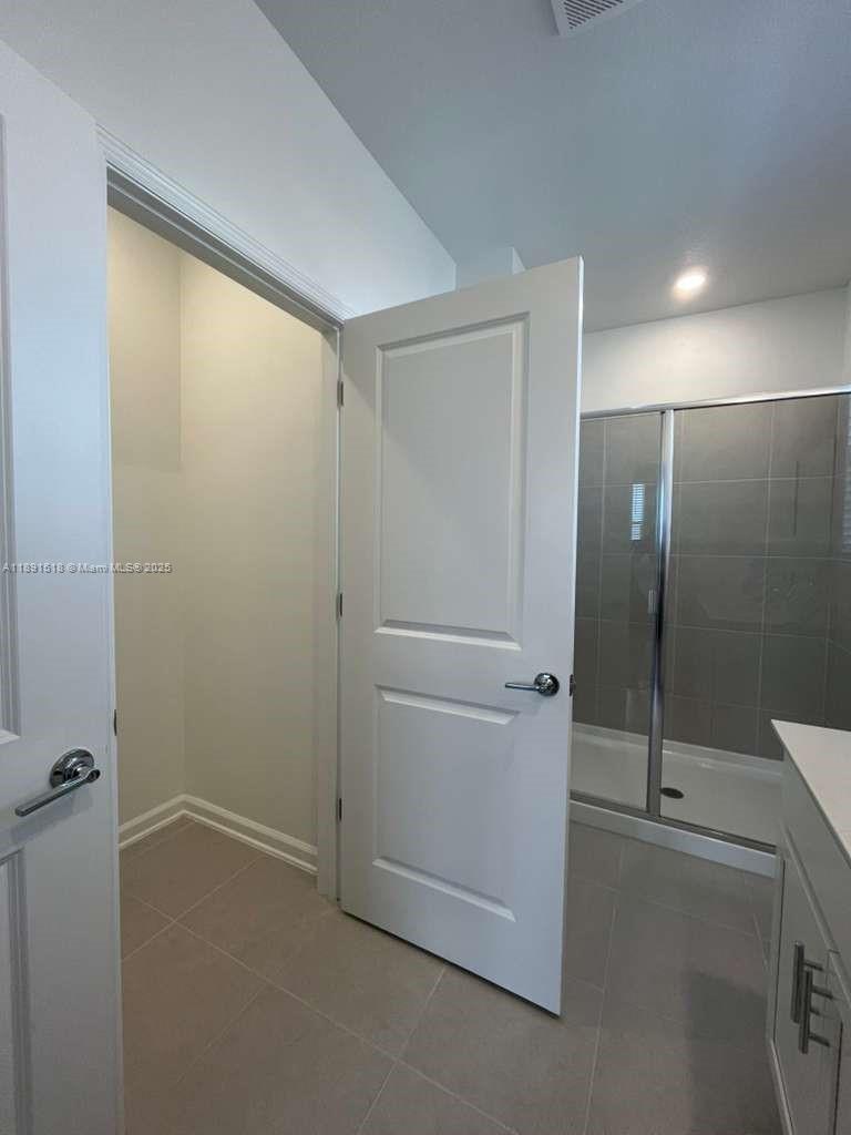 5984 Zen Way, Unit 5984 Clermont, FL 34714 - Photo 24 of 51 a bathroom with a shower and a glass door