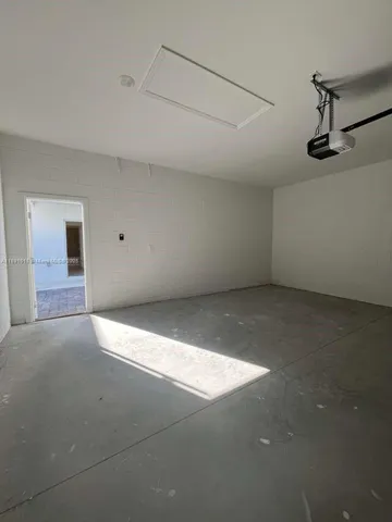 an empty room with windows and entrance