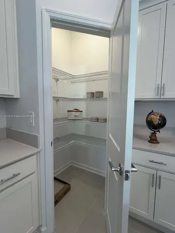 a kitchen with stainless steel appliances a sink a stove a microwave a center island and cabinets