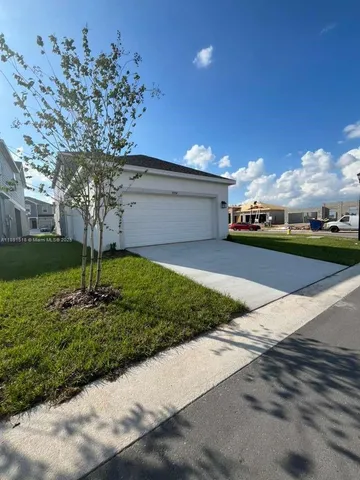 a large kitchen with stainless steel appliances a refrigerator stove a sink and a microwave