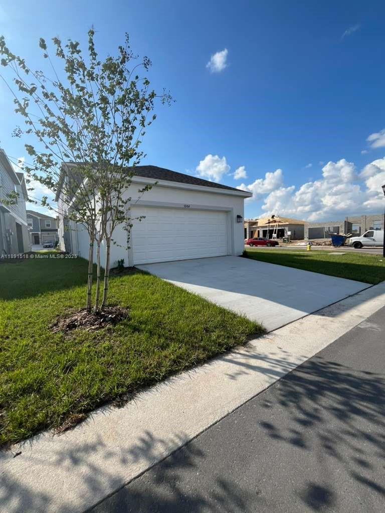5984 Zen Way, Unit 5984 Clermont, FL 34714 - Photo 36 of 51 a view of a garden with a tree in the background