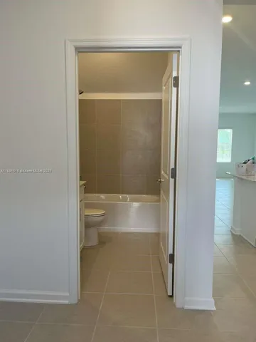 a bathroom with a double vanity sink toilet and bathtub