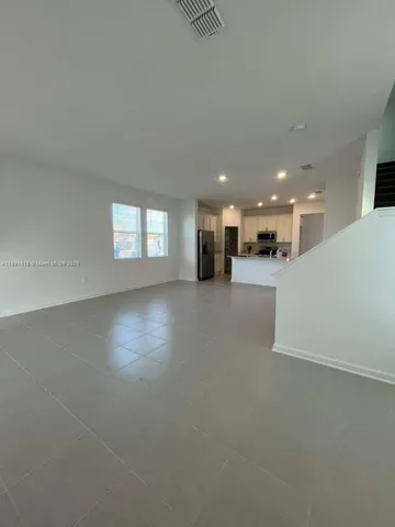 a view of an empty room and a window