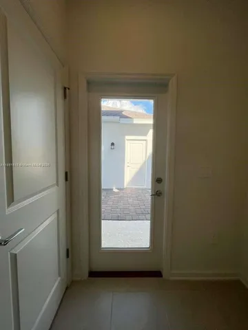 a view of an empty room and a window