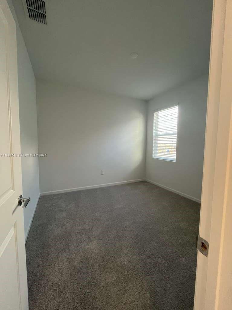 5984 Zen Way, Unit 5984 Clermont, FL 34714 - Photo 48 of 51 an empty room with a window