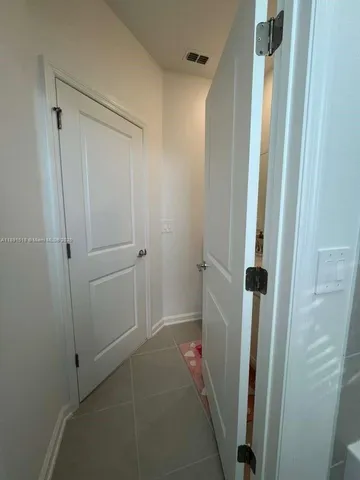 a bathroom with a shower and a glass door