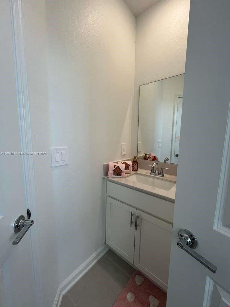 5984 Zen Way, Unit 5984 Clermont, FL 34714 - Photo 7 of 51 a bathroom with a sink and mirror