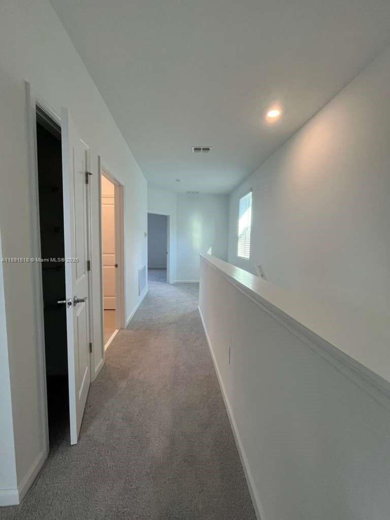5984 Zen Way, Unit 5984 Clermont, FL 34714 - Photo 9 of 51 a view of hallway with bathroom and sink