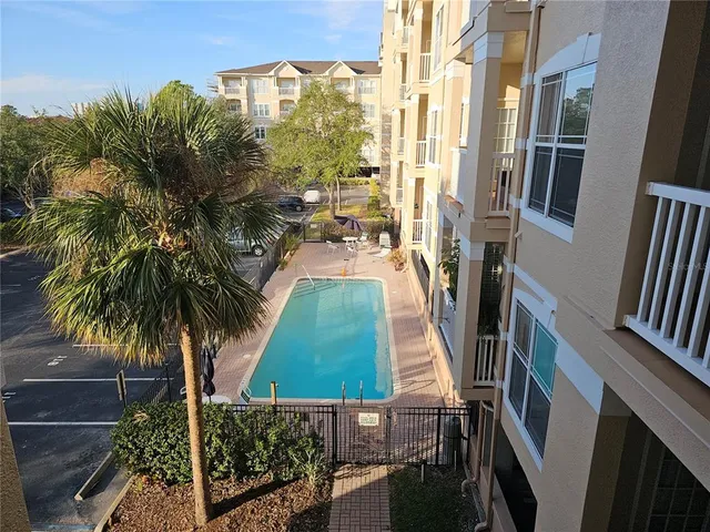 a view of a house with backyard and swimming pool