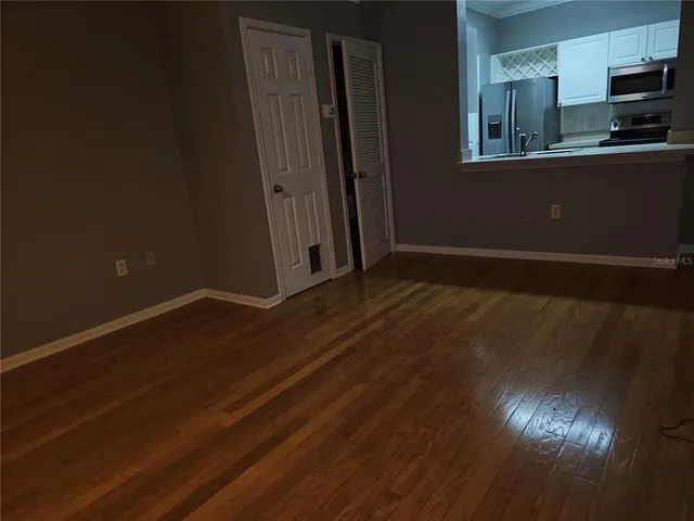 a view of room with window and wooden floor
