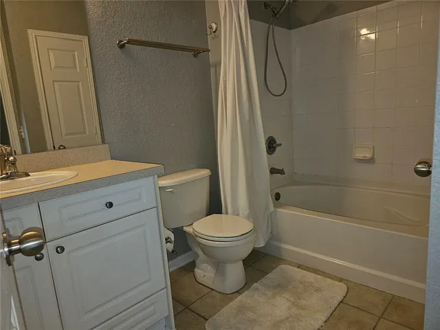a bathroom with a toilet sink and shower