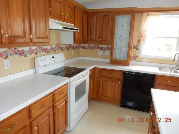 a kitchen with stainless steel appliances a stove a sink and a microwave