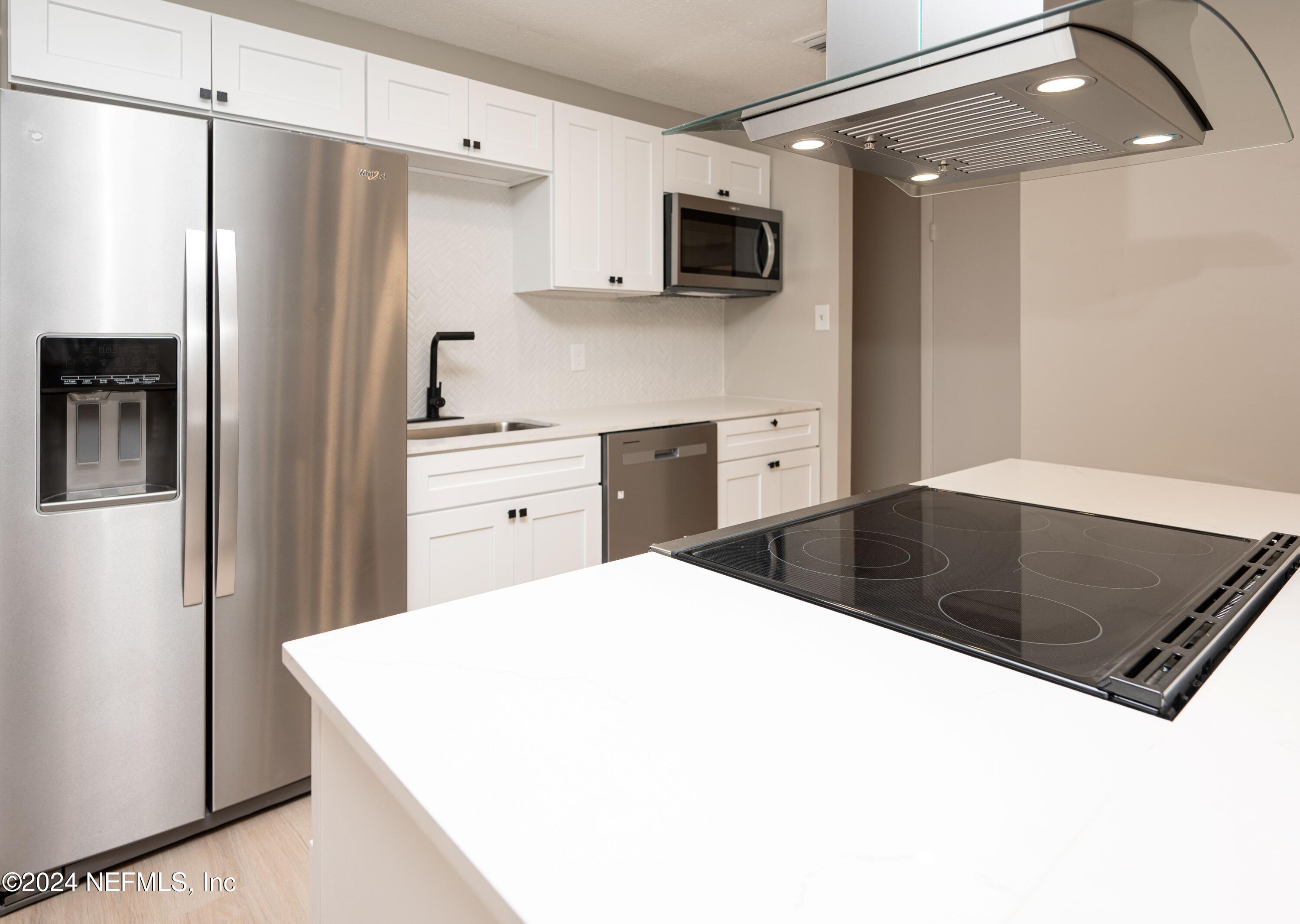 1195 Pecan Cove Jacksonville, FL 32221 - Photo 26 of 54 a kitchen with stainless steel appliances a refrigerator sink and microwave