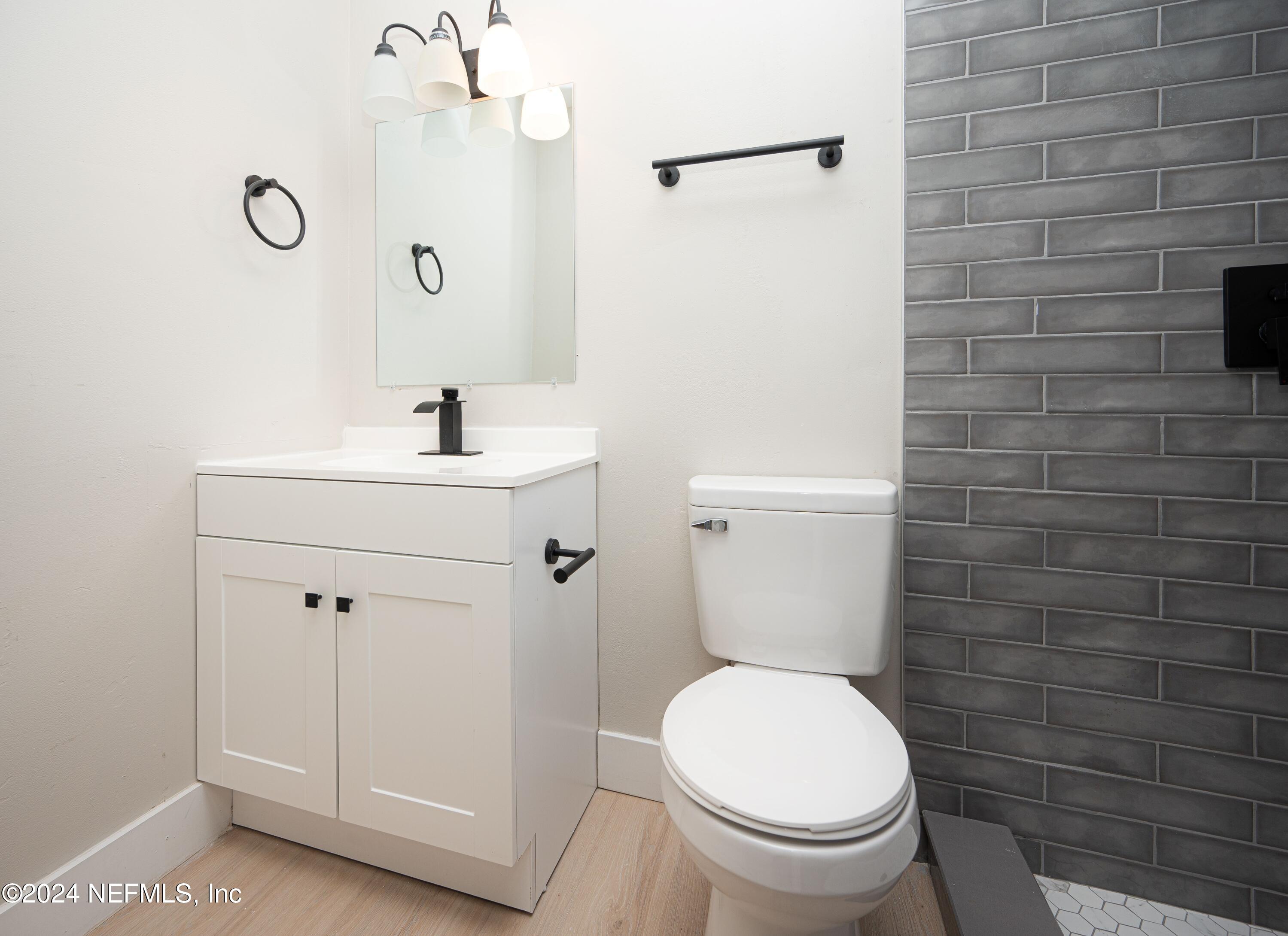 1195 Pecan Cove Jacksonville, FL 32221 - Photo 50 of 54 a bathroom with a toilet a sink and mirror