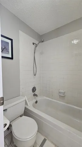a bathroom with a toilet and a bath tub