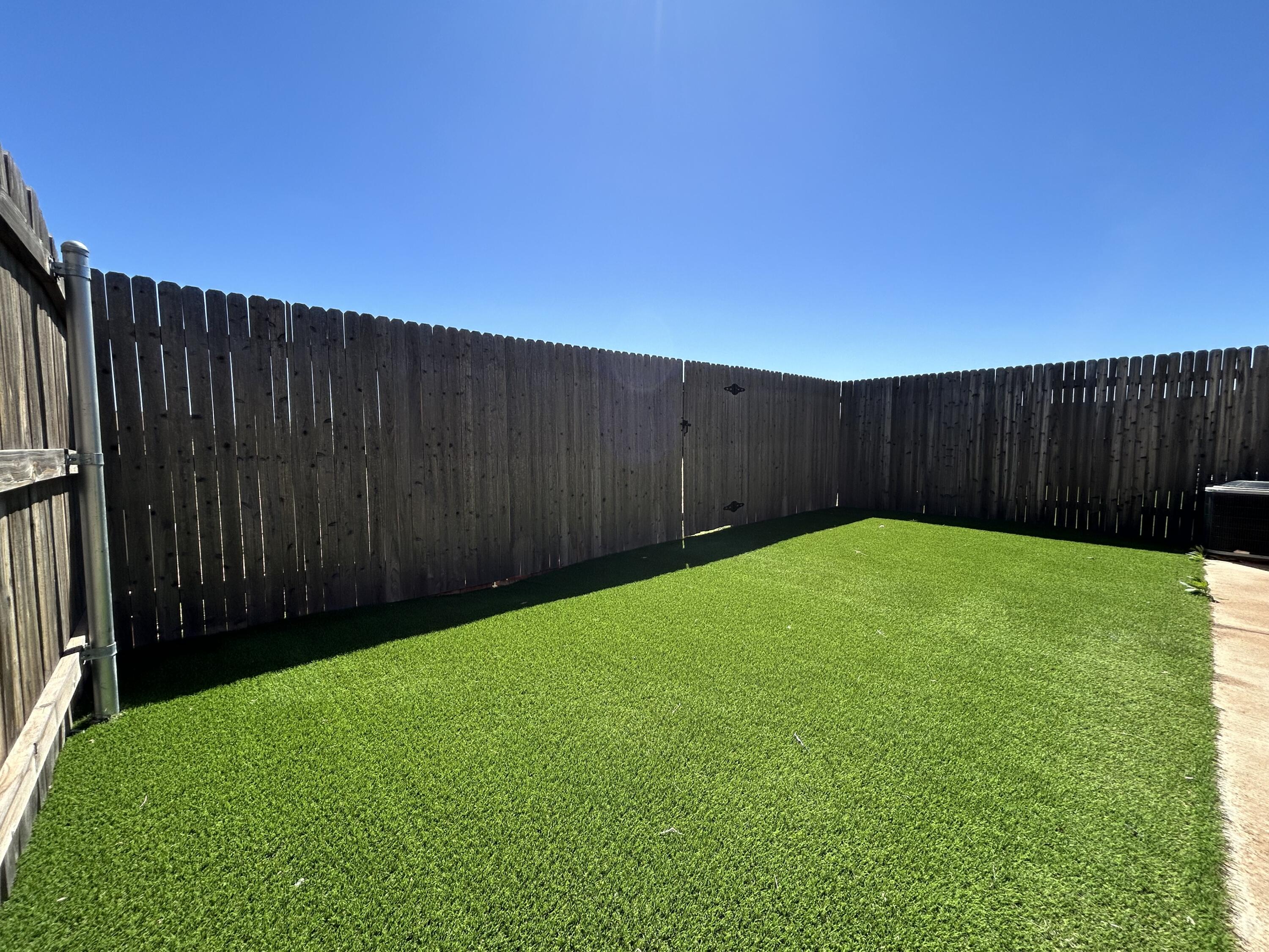 2547 138th Street Lubbock, TX 79423 - Photo 11 of 11 a view of yard with swimming pool and wooden fence