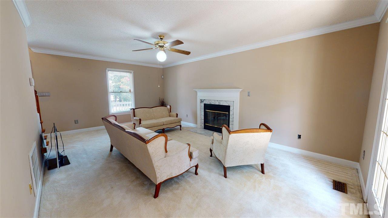 4232 Birmingham Way Raleigh, NC 27604 - Photo 14 of 30 a living room with furniture and a chandelier