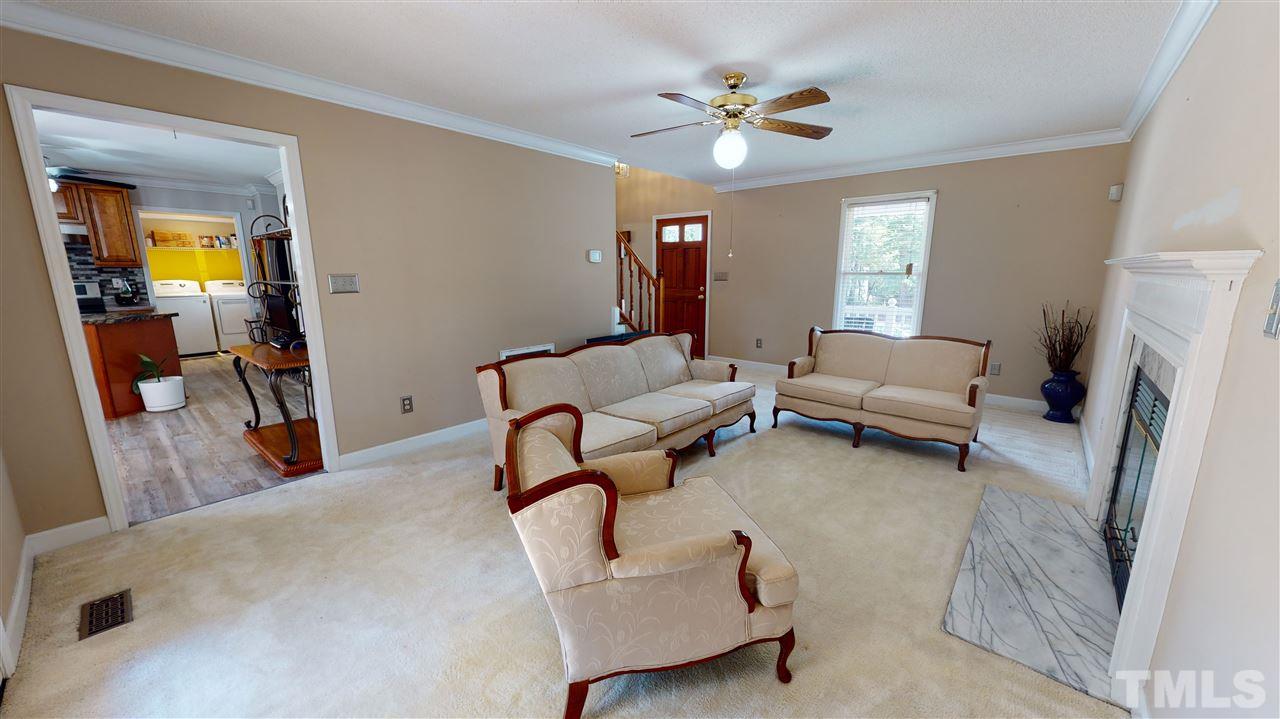 4232 Birmingham Way Raleigh, NC 27604 - Photo 16 of 30 a living room with furniture and a chandelier