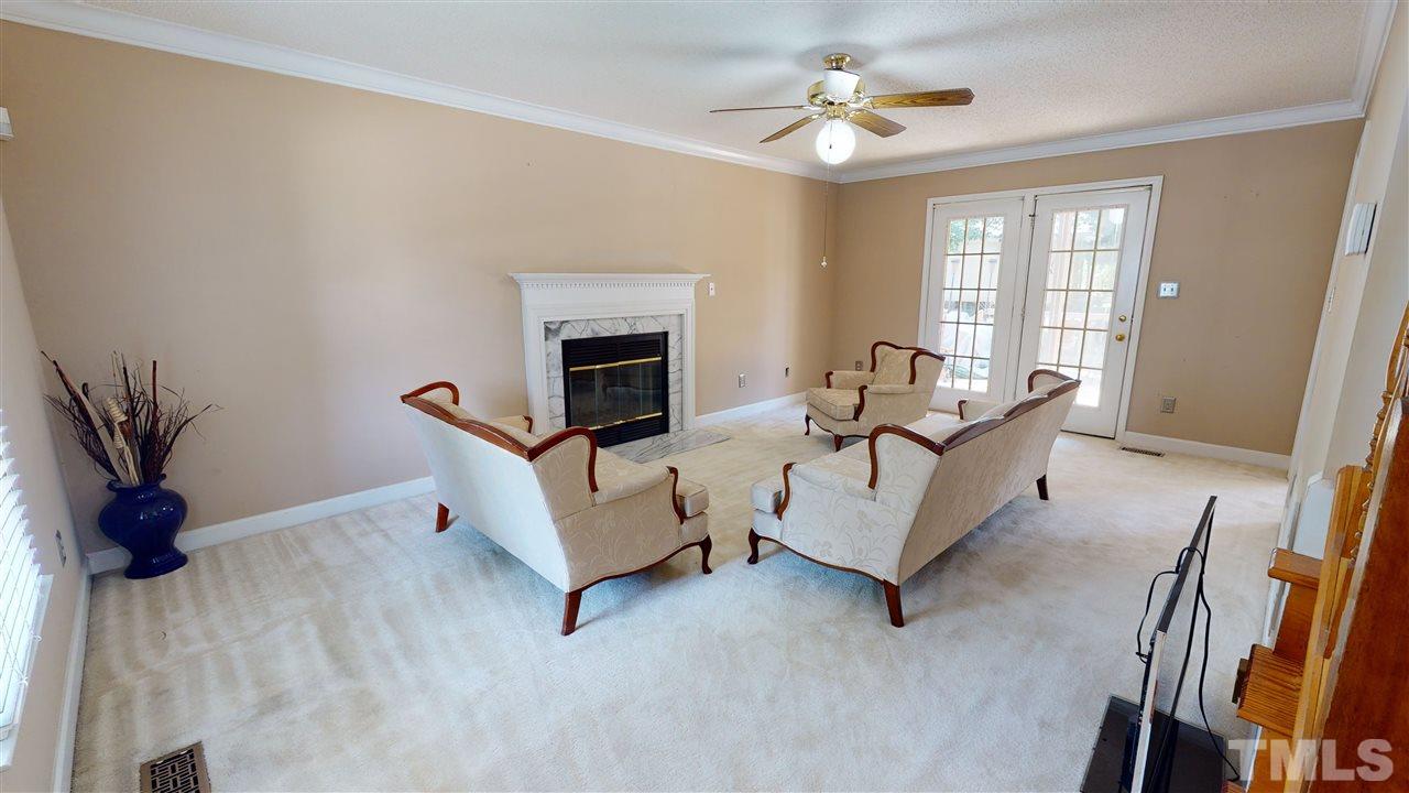 4232 Birmingham Way Raleigh, NC 27604 - Photo 5 of 30 a living room with furniture and a fireplace