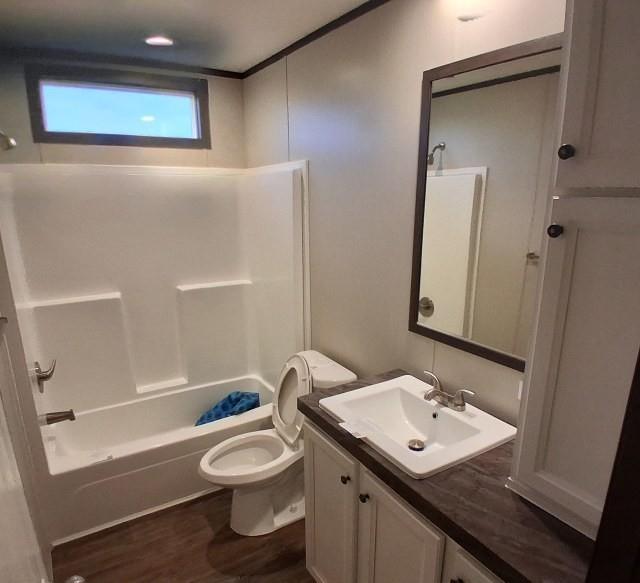 798 North 4190 Road Hugo, OK 74743 - Photo 13 of 16 a bathroom with a toilet a sink and bathtub