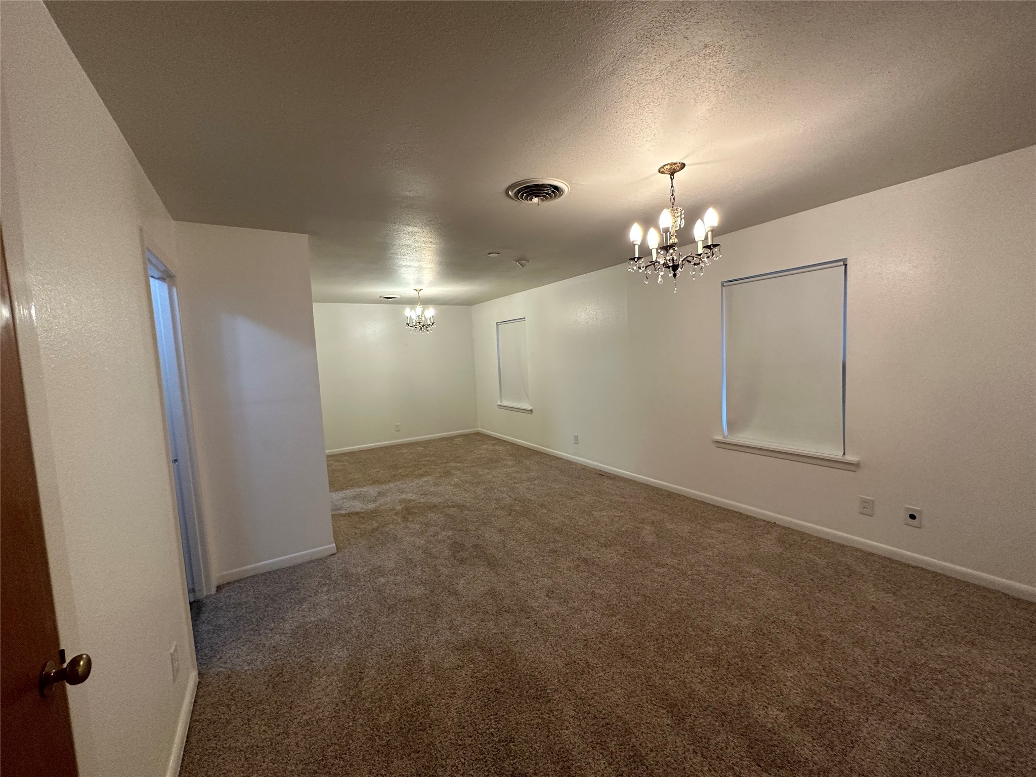 4101 Philco Drive Houston, TX 77080 - Photo 2 of 23 en empty room with chandelier fan and refrigerator