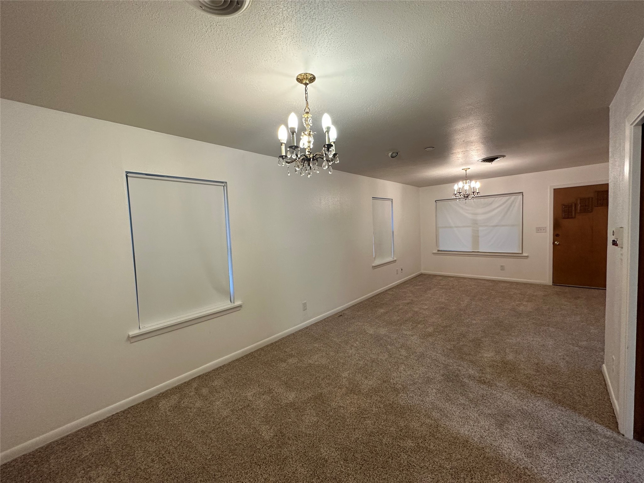 4101 Philco Drive Houston, TX 77080 - Photo 4 of 23 en empty room with chandelier and window