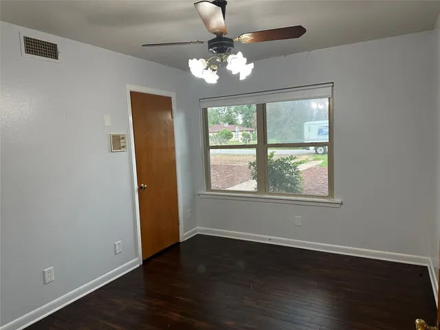 a view of a room with wooden floor and chandelier