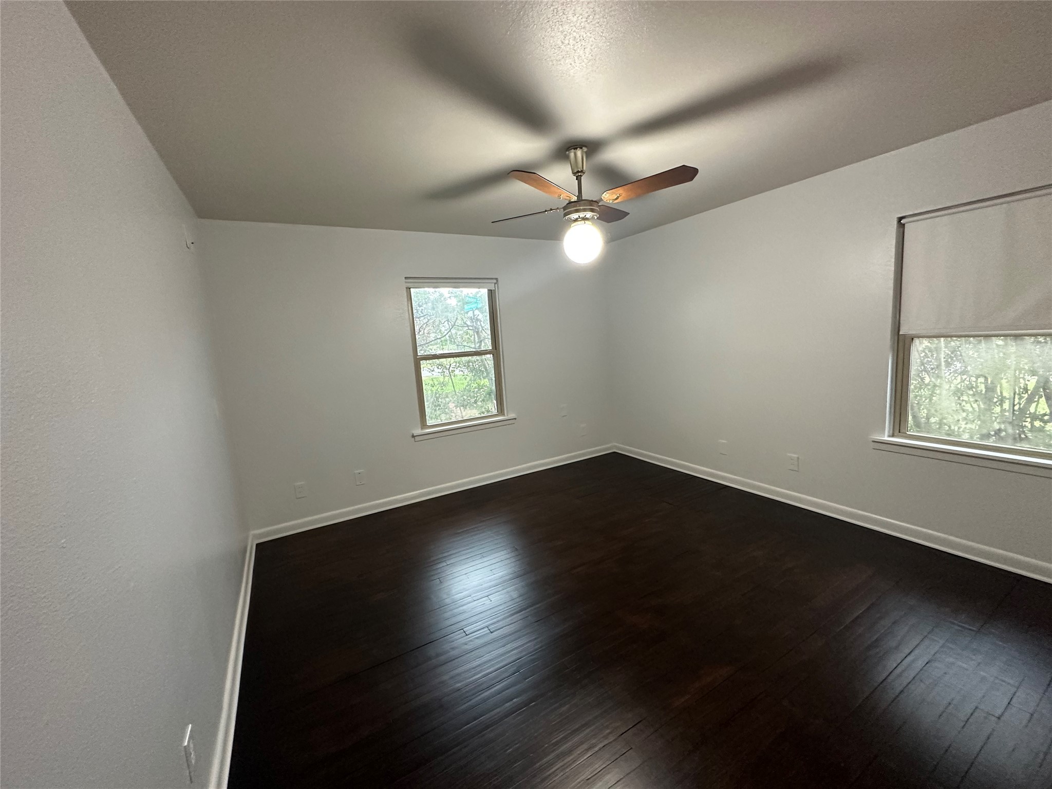 4101 Philco Drive Houston, TX 77080 - Photo 6 of 23 an empty room with wooden floor fan and windows