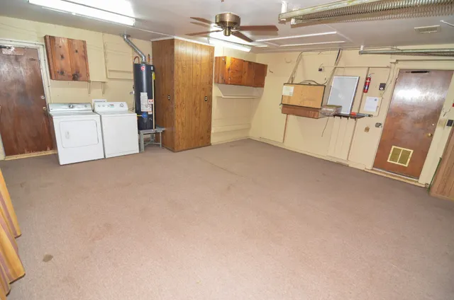 a view of a storage & utility room with refrigerator and washer