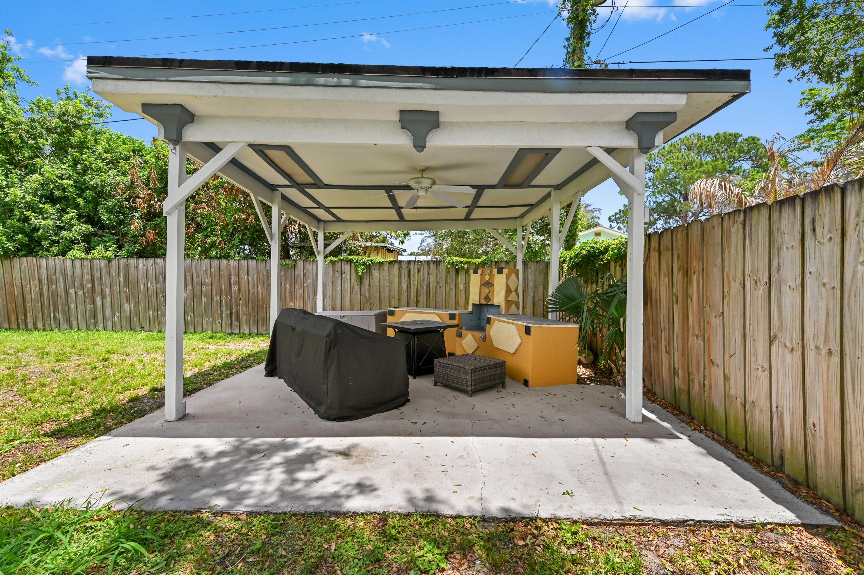 5709 Southeast Indigo Avenue Stuart, FL 34997 - Photo 2 of 26 a view of outdoor space yard and patio