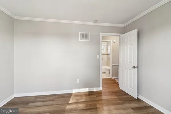 a view of an empty room with wooden floor