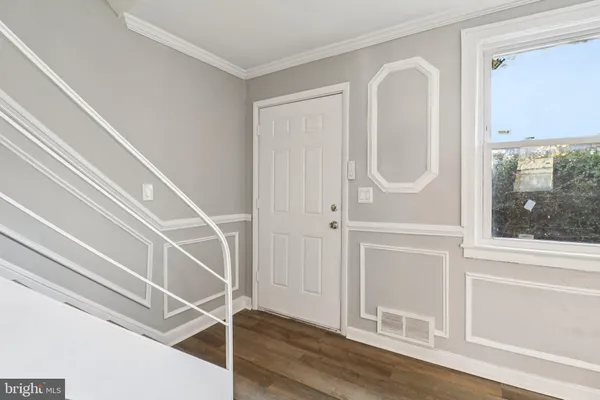 a view of a room with wooden floor and windows