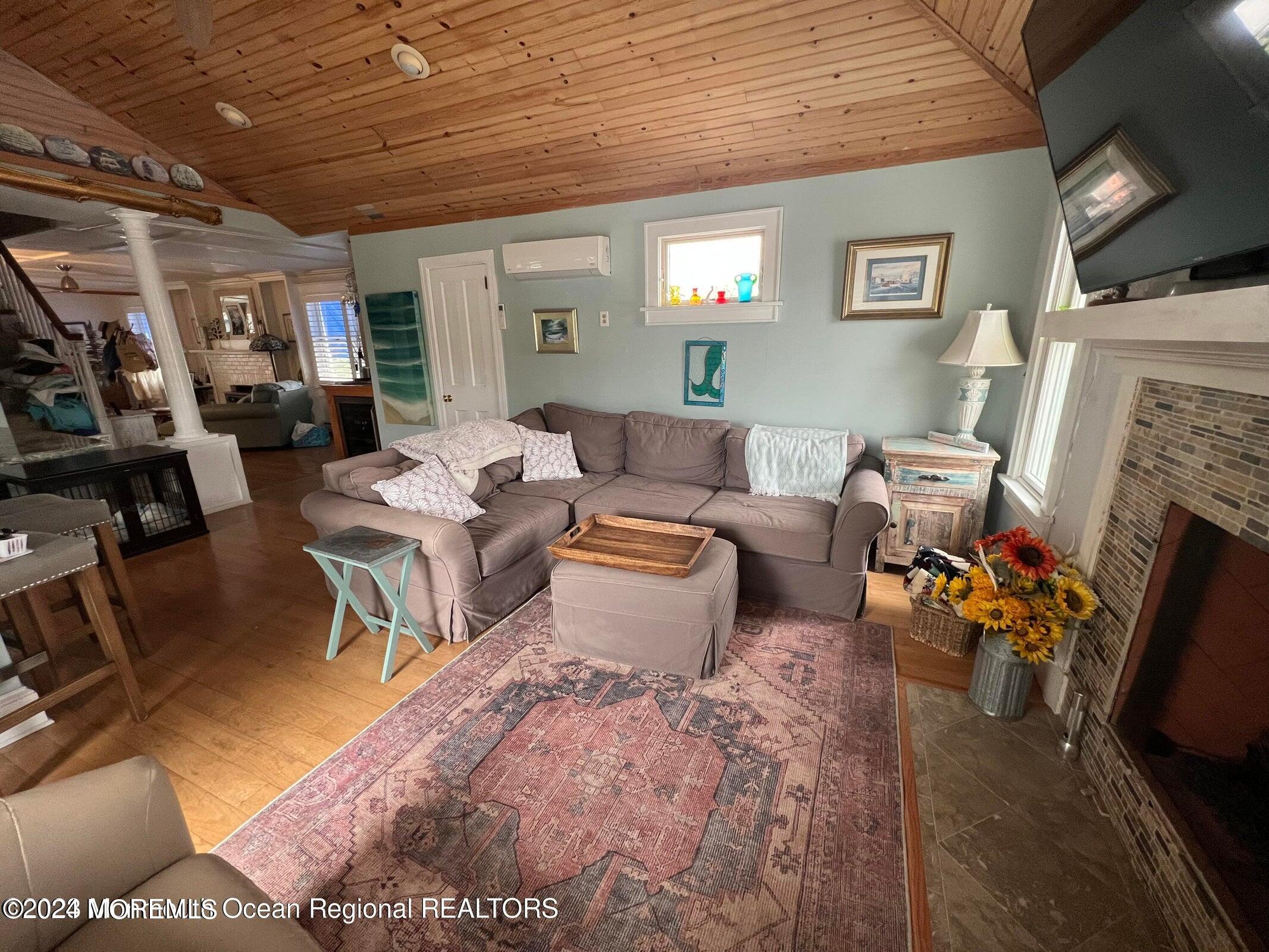 106 Mathis Place, Unit PO243 Mantoloking, NJ 08738 - Photo 11 of 25 a living room with furniture and a fireplace