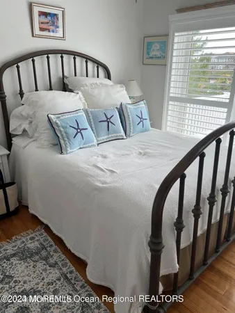 a bed sitting in a bedroom next to a window