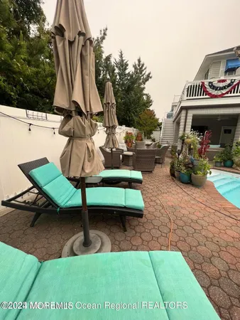 a view of swimming pool with a bench and trees