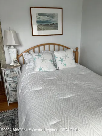 a large bed sitting in a bedroom next to a lamp