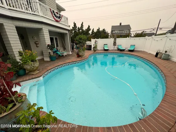 a view of a swimming pool with lounge chair