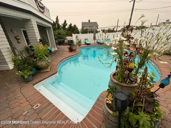 a view of a backyard with sitting area