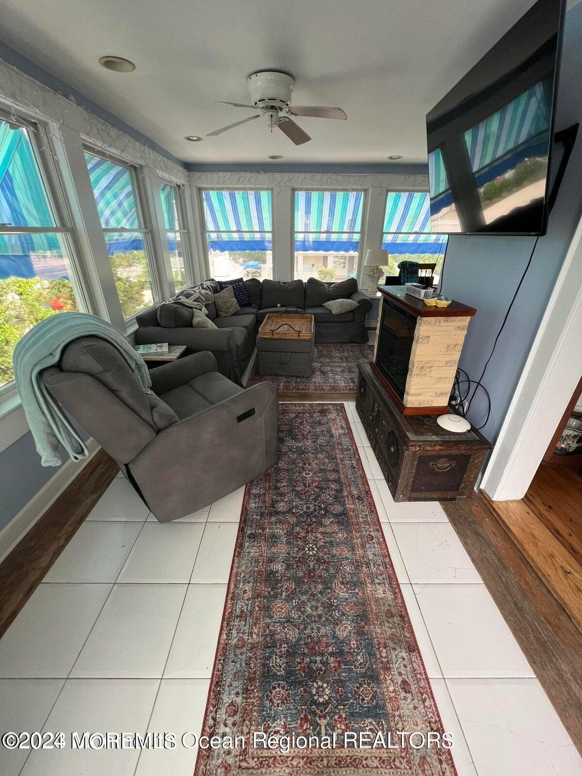 106 Mathis Place, Unit PO243 Mantoloking, NJ 08738 - Photo 10 of 25 a living room with furniture and a flat screen tv